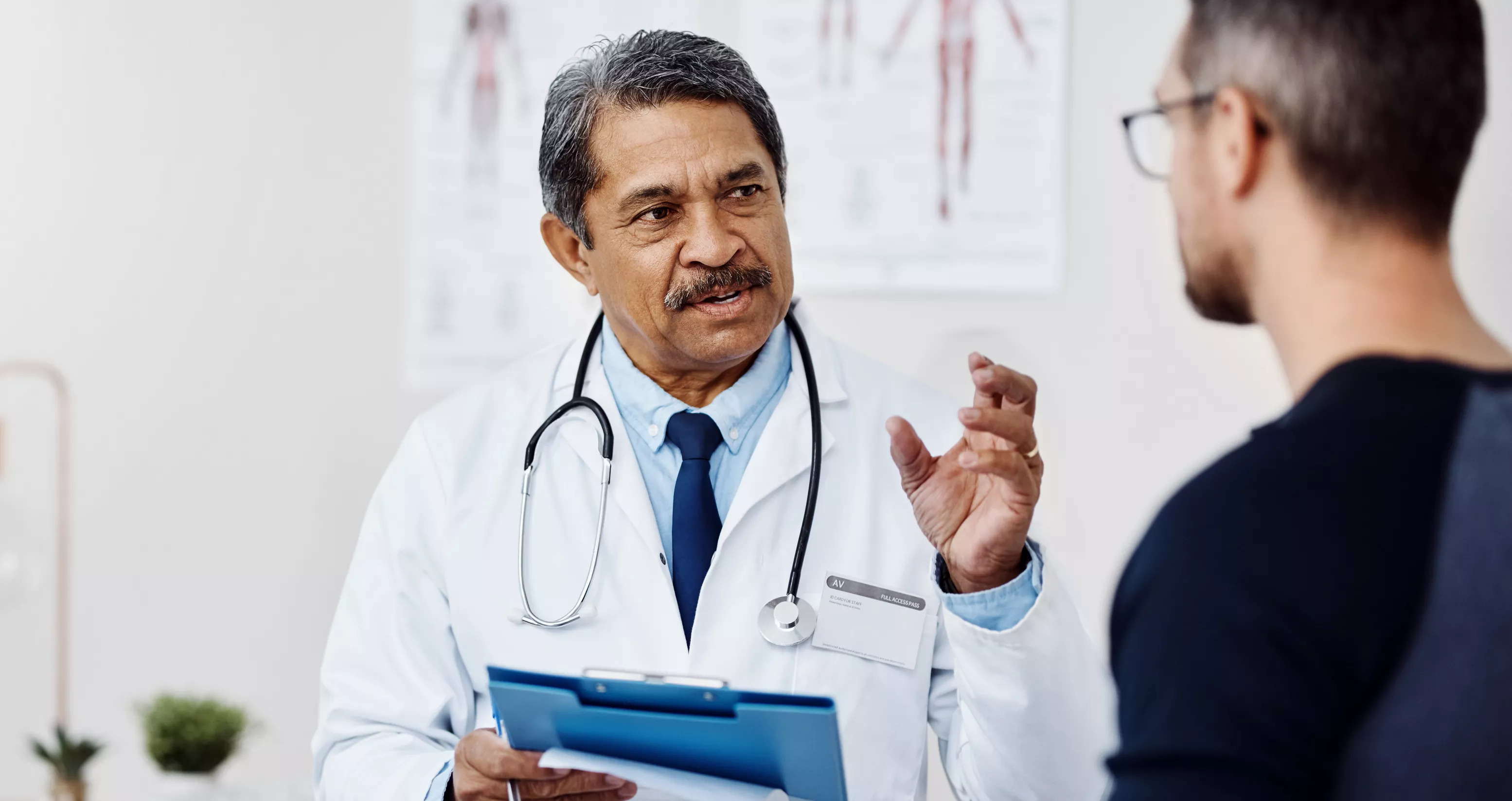 Confident doctor consulting a patient inside a medical setting